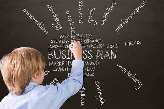 Free Photo | Boy writing on a blackboard