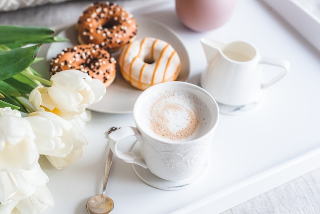 https://image.freepik.com/free-photo/breakfast-in-bed-with-cup-with-cappuccino-doughnuts-and-white-tulips_106119-628.jpg