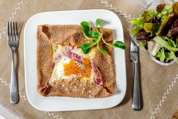 Premium Photo | Breton crepe with egg in white plate