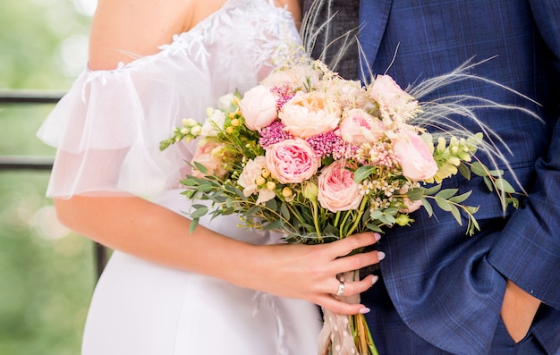 Premium Photo Bride And Groom Holding Beautiful Wedding Bouquet Of Flowers