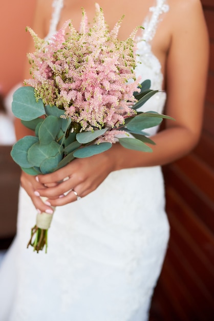 Bride Holding A Bouquet Of Flowers In A Rustic Style Wedding