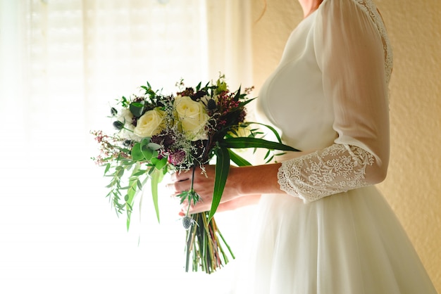 Premium Photo | Bride holding her wedding bouquet