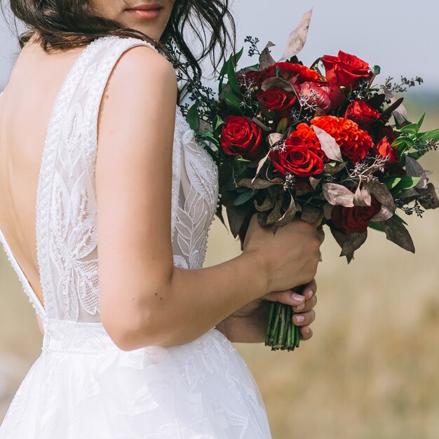 Premium Photo | Bride in wedding dress and holding wedding bouquet