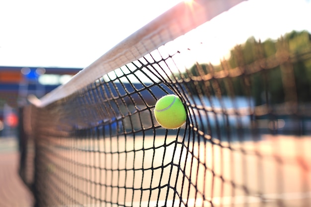 premium-photo-bright-greenish-yellow-tennis-ball-hitting-the-net
