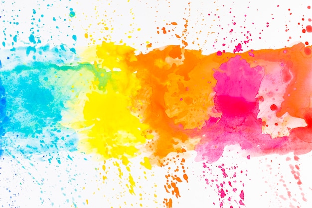 Bright splashes of dye on white Free Photo