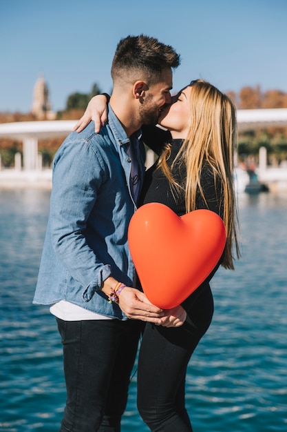 Free Photo | Bright young couple kissing romantically on waterfront