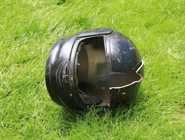 Premium Photo | Broken motorcycle helmet on the ground