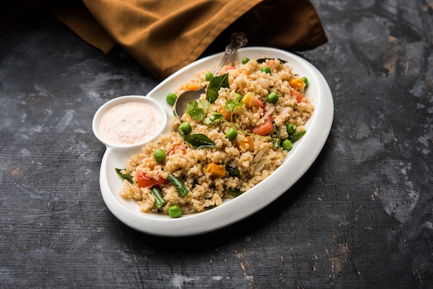 Premium Photo Broken Wheat Or Daliya Upma Served In A Bowl