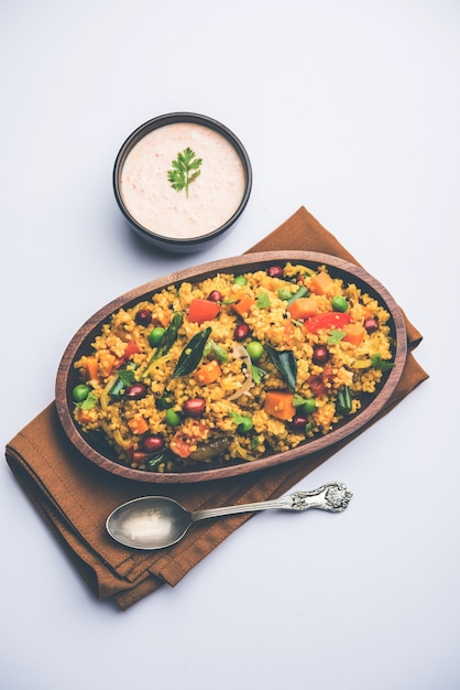 Premium Photo Broken Wheat Or Daliya Upma Served In A Bowl