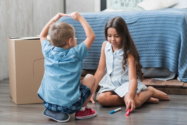 Free Photo Brother And Sister Playing Together In Bedroom