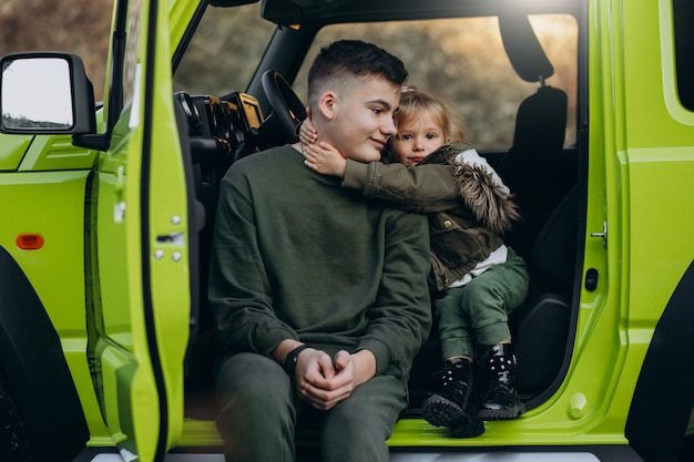 Brother With Little Sister Sitting In Green Car Photo Free Download