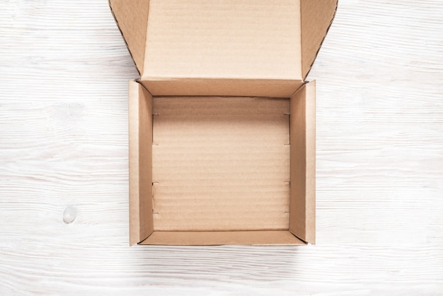 Download Brown cardboard box, mock up, on wooden background ...