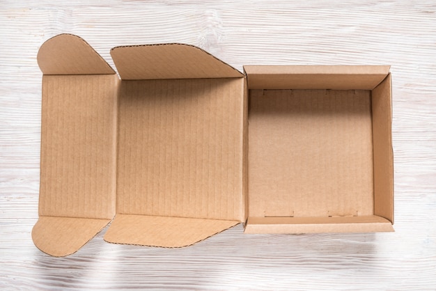 Download Brown cardboard box, mock up, on wooden background ...