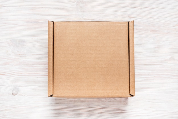 Download Brown cardboard box, mock up, on wooden background ...