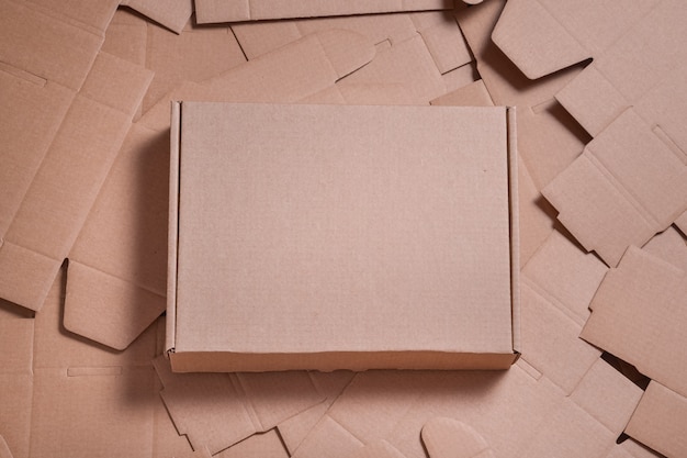 Download Premium Photo | Brown carton box on unfolded cardboard boxes