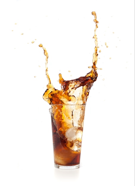 Brown drink falling in ice Photo | Free Download