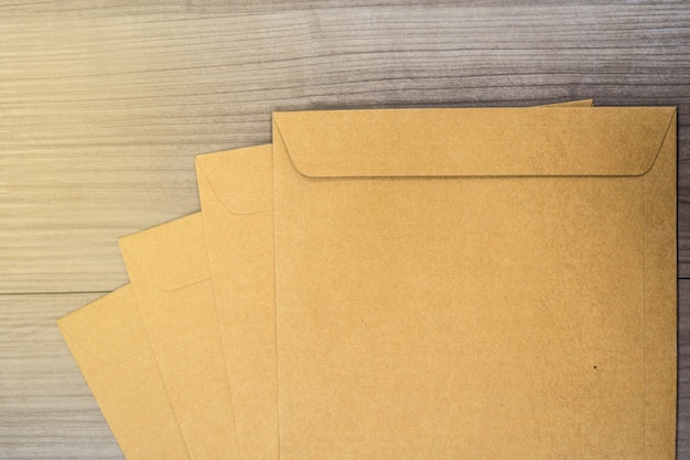 Premium Photo | A brown envelope on a wooden floor surface