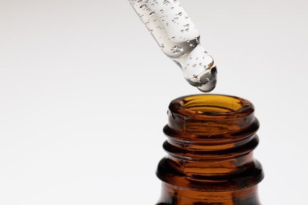 Premium Photo | Brown glass bottles with oily skincare serum close up