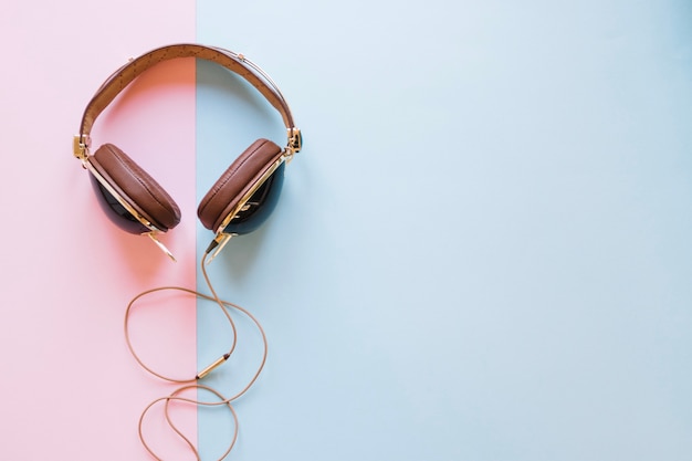Brown headphones on pastel background Free Photo