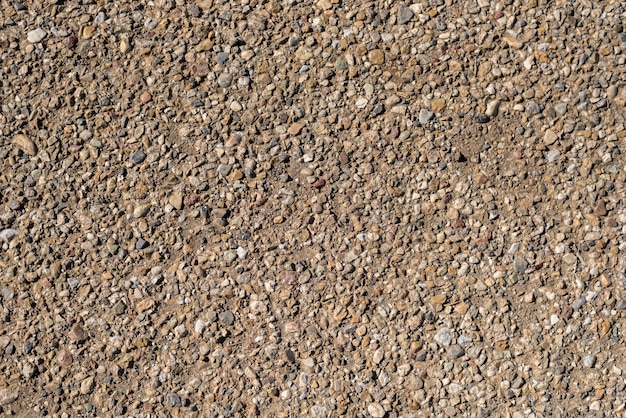 茶色の自然な砂利の石は 地面のテクスチャの背景にサイズをランダム化 プレミアム写真