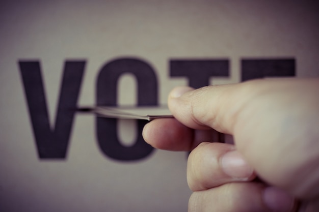Brown paper insert in vote box, democracy concept, retro tone Premium Photo