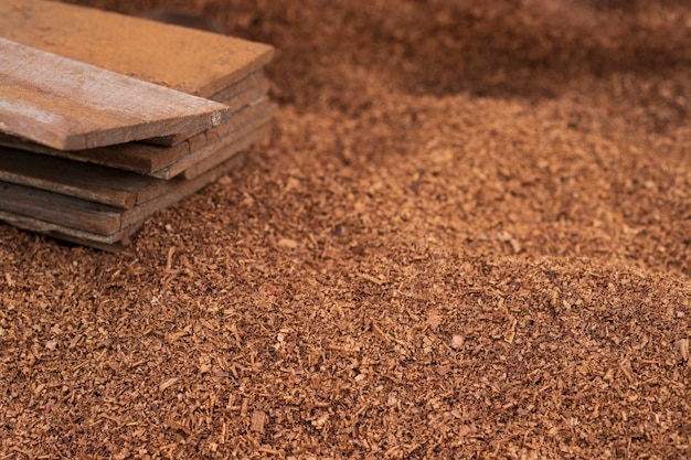 Premium Photo | Brown sawdust piles on the floor, which is caused by ...