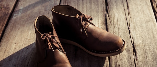 Premium Photo | Brown stylish boots on wood
