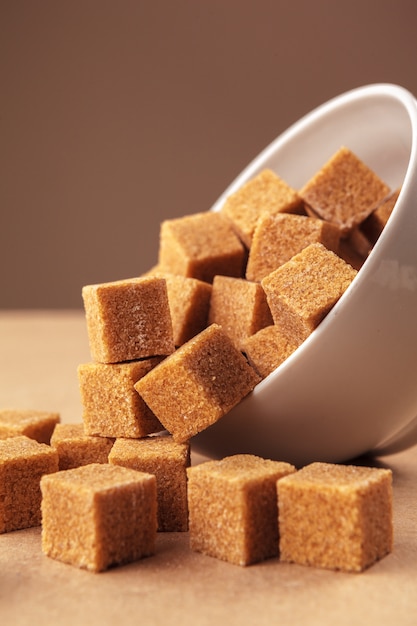 Premium Photo | Brown sugar cubes in a bowl