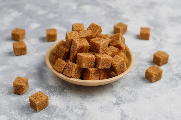 Brown sugar cubes on concrete ,top view Free Photo