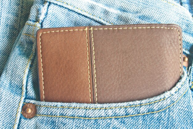 Premium Photo | Brown wallet in jeans trousers back pocket