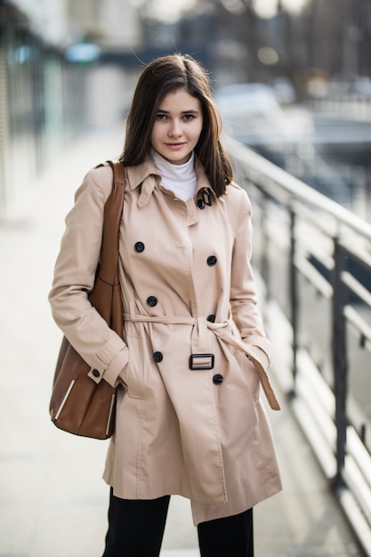 Free Photo | Brunette girl on the street in coffee coat and brown ...