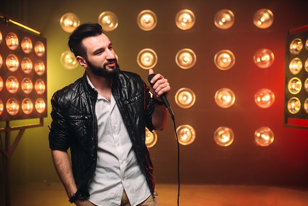 Premium Photo | Brutal bearded singer with microphone on the stage