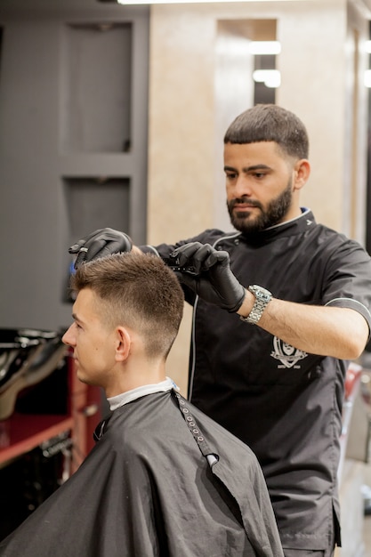 Premium Photo Brutal Guy In Modern Barber Shop