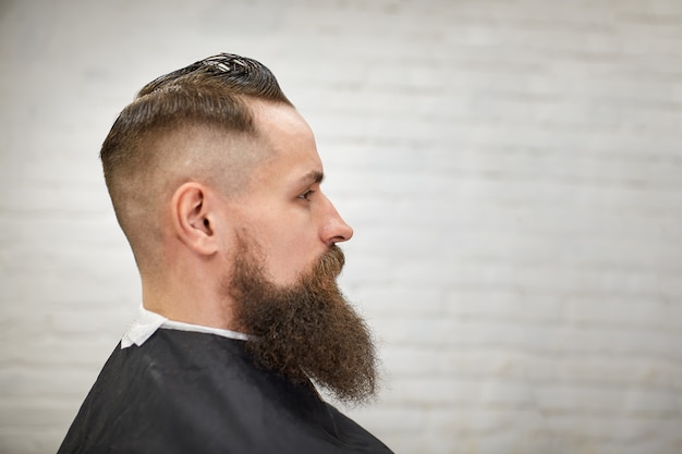 Brutal Guy In Modern Barber Shop Hairdresser Makes Hairstyle A
