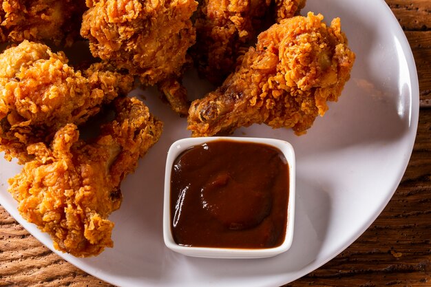 Premium Photo Bucket Full Of Crispy Kentucky Fried Chicken With Smoke And Barbecue Sauce On Brown Background Selective Focus