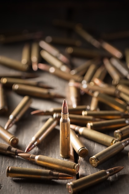 Premium Photo | Bullets on wood table