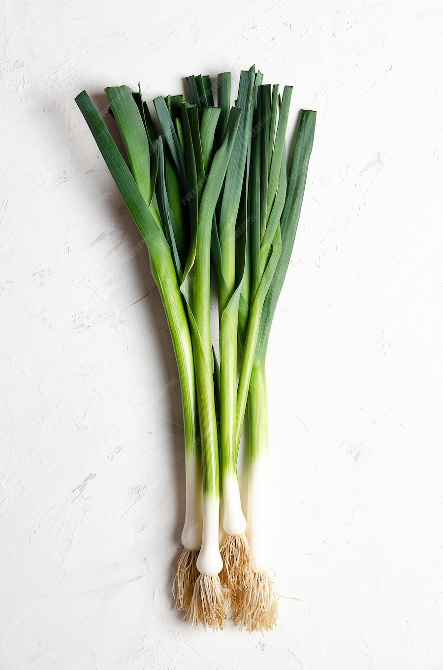 Premium Photo | A bunch of fresh leeks on a white background