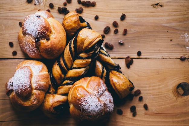 Buns and raisins om wooden tabletop  Photo | Free Download