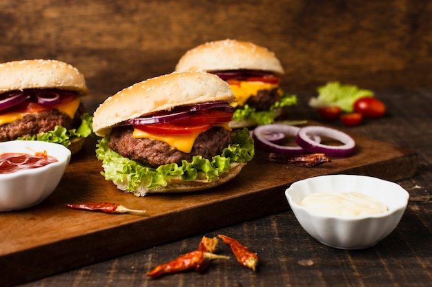 Free Photo | Burgers with ketchup on wood tray