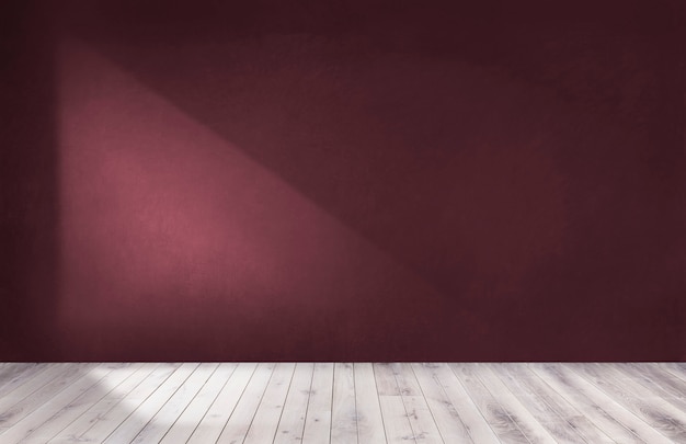 Burgundy red wall in an empty room with a wooden floor | Premium Photo
