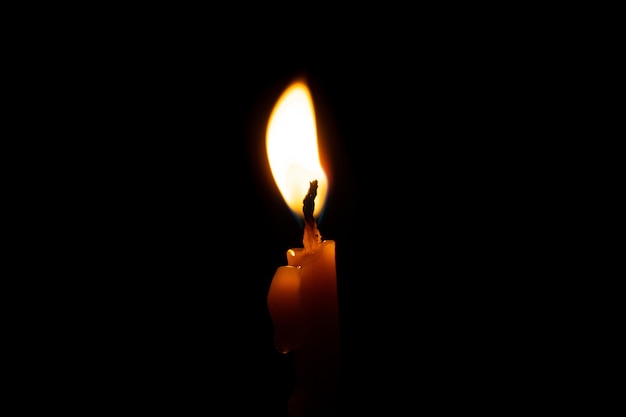 Premium Photo | Burning candle on black