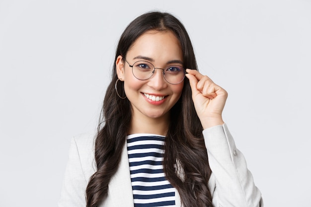 Business, finance and employment, female successful entrepreneurs concept. talented young asian female it programmer in glasses, customer support manager smiling at camera Free Photo