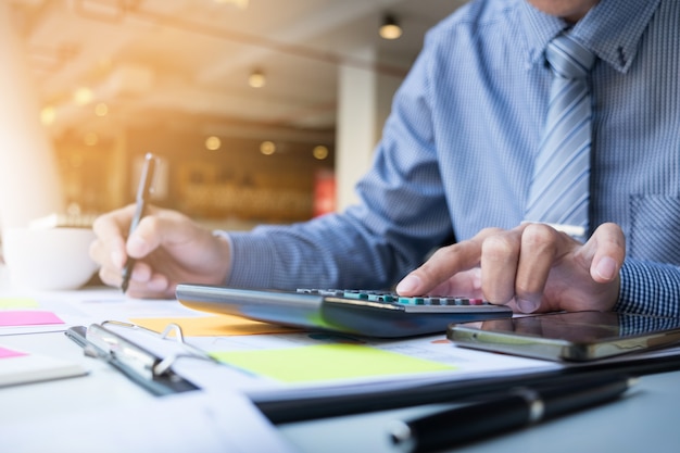 Business finance man calculating budget numbers, Invoices and financial adviser working. Free Photo