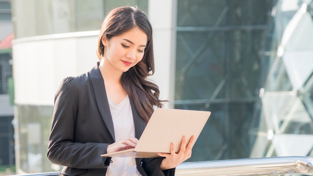 Premium Photo | Business girl with computer notebook and city