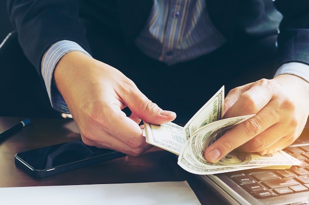 Business man counting dollar banknote - online business concept Free Photo