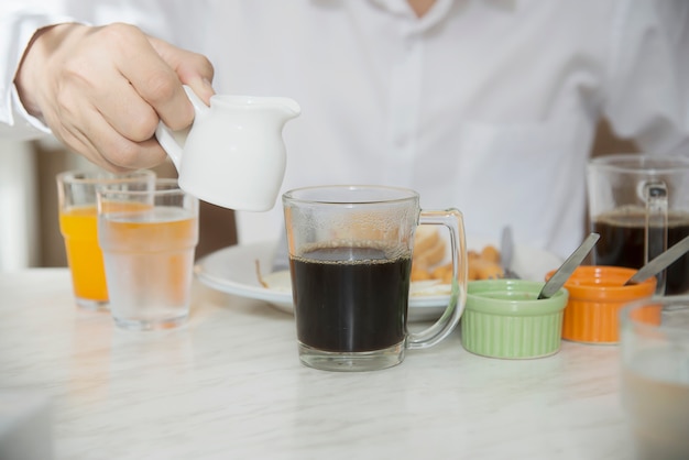 Business man eat the american breakfast set in a hotel Free Photo