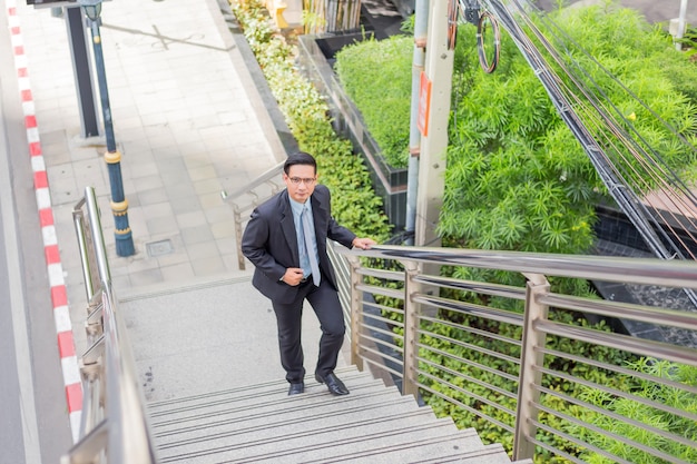 premium-photo-business-man-going-up-the-stairs-in-a-rush-hour-to-work