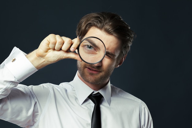 Premium Photo | Business Man Holding Magnifying Glass