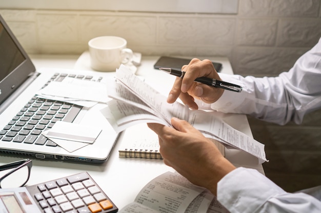 Premium Photo  A business man holding pen while looking at the 