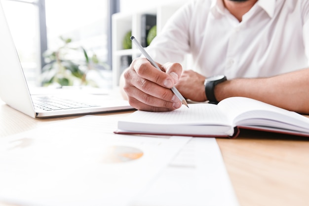 Premium Photo | Business man in white shirt sitting at table and ...